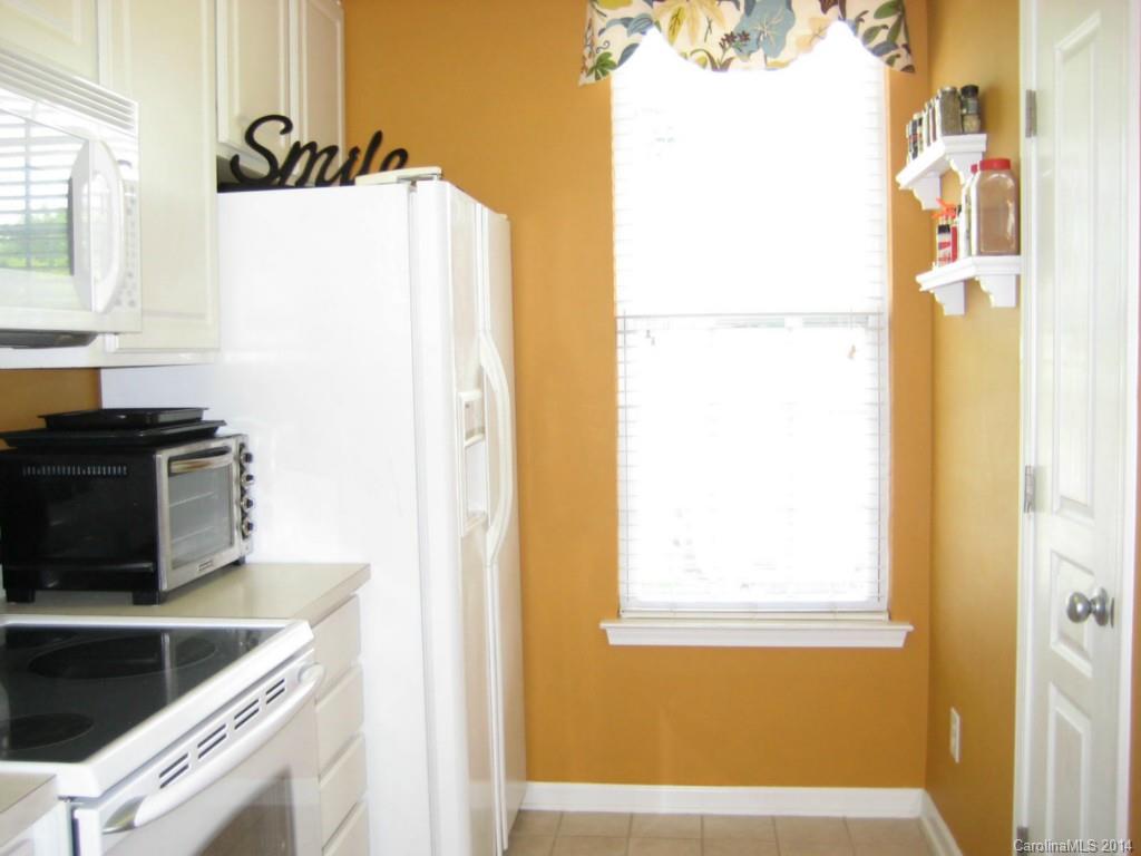 334 Sugar Ridge Court, Unit 102 Fort Mill, SC 29708 - Photo 11 of 18 a kitchen with a refrigerator and a stove
