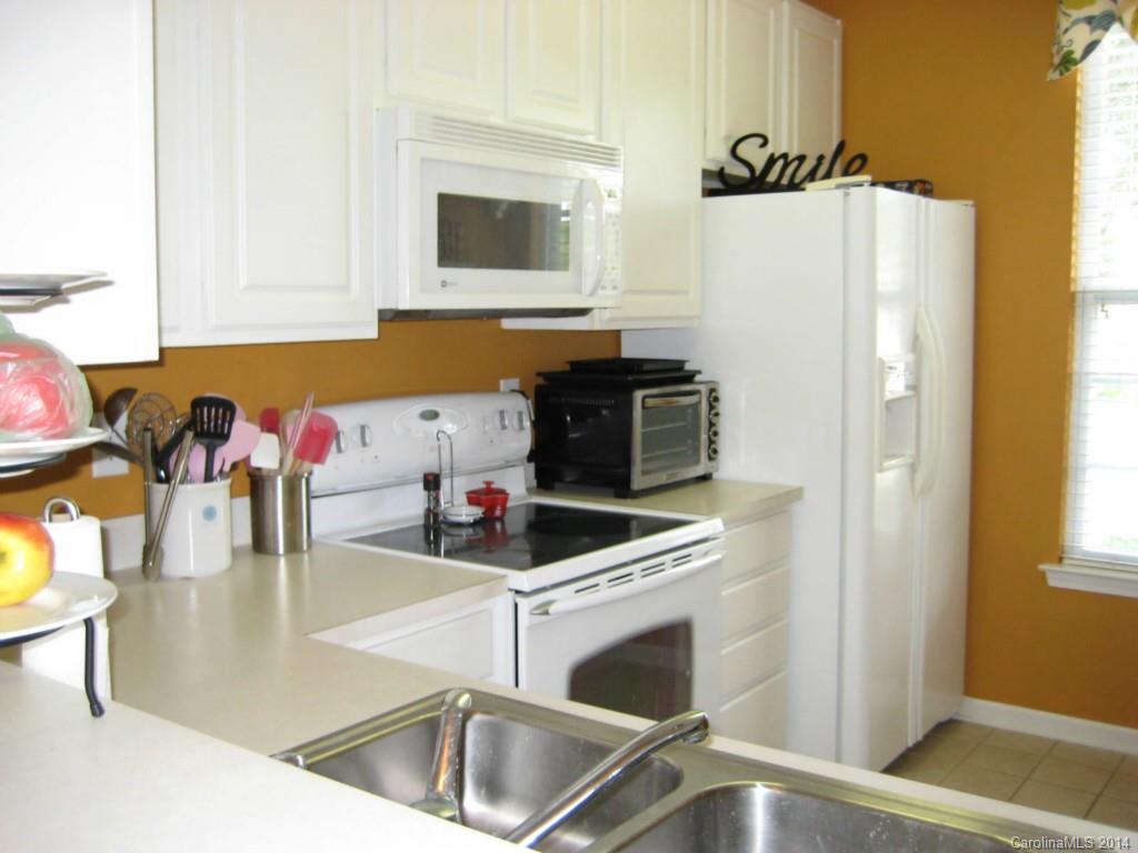 334 Sugar Ridge Court, Unit 102 Fort Mill, SC 29708 - Photo 12 of 18 a kitchen with stainless steel appliances a stove a microwave and a sink