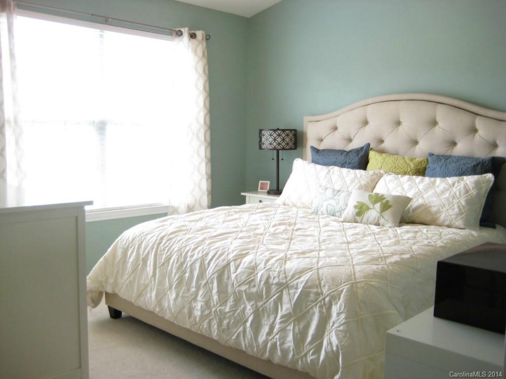 334 Sugar Ridge Court, Unit 102 Fort Mill, SC 29708 - Photo 13 of 18 a bed sitting in a bedroom next to a window