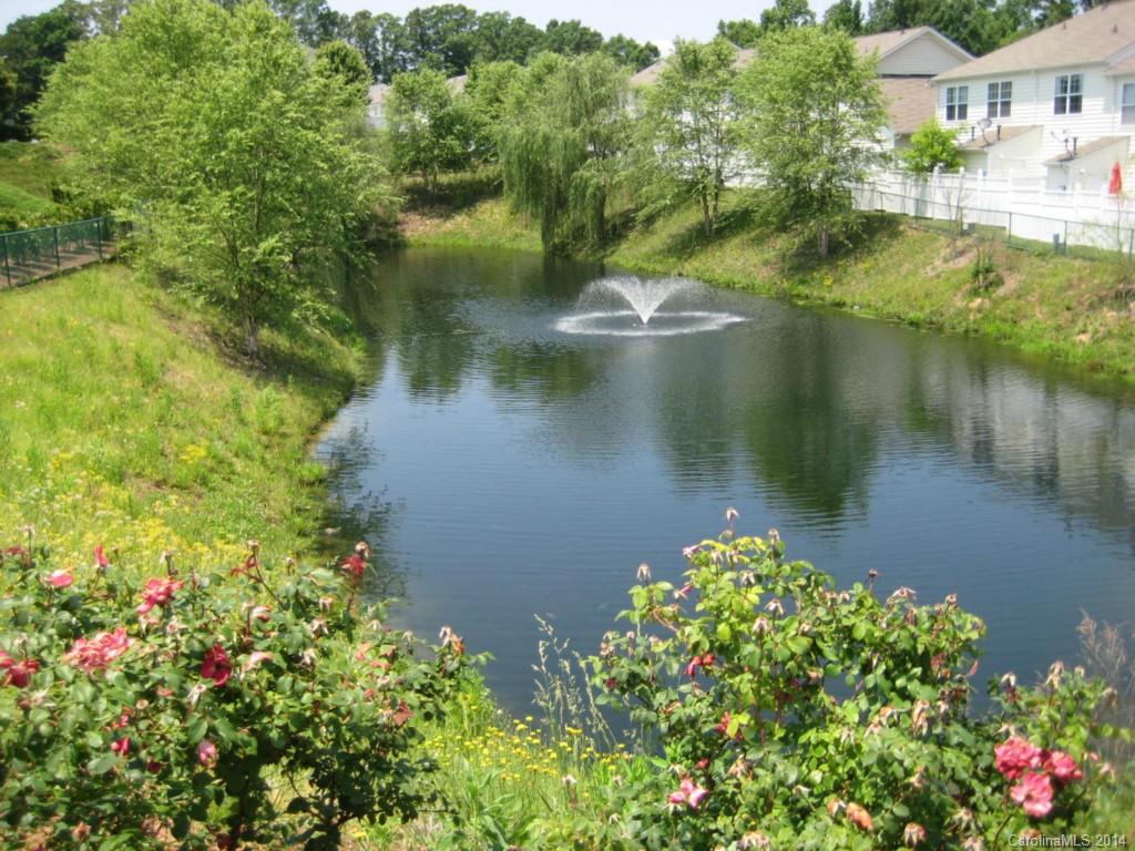 334 Sugar Ridge Court, Unit 102 Fort Mill, SC 29708 - Photo 15 of 18 a view of a lake with a house in the background