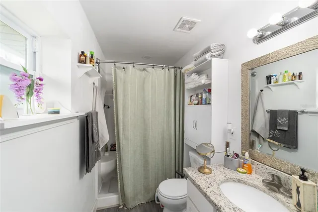 a bedroom that has a bed and a chandelier