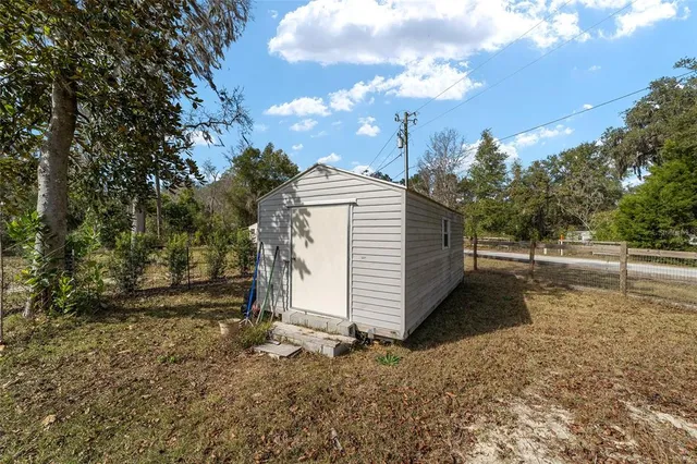 a view of yard with tree in the background