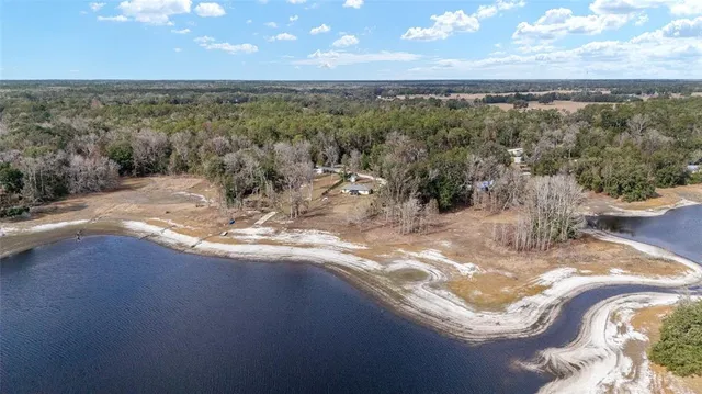 a view of a yard with wooden fence