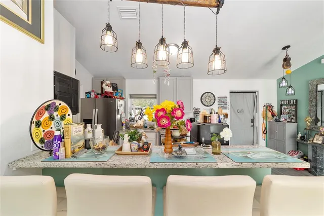 a view of dining room and kitchen with furniture wooden floor and a chandelier