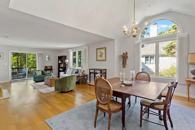 a view of a dining room with furniture a chandelier and wooden floor