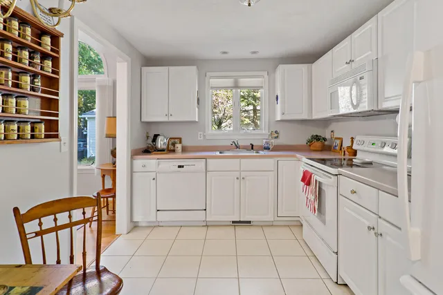 a kitchen with cabinets and window