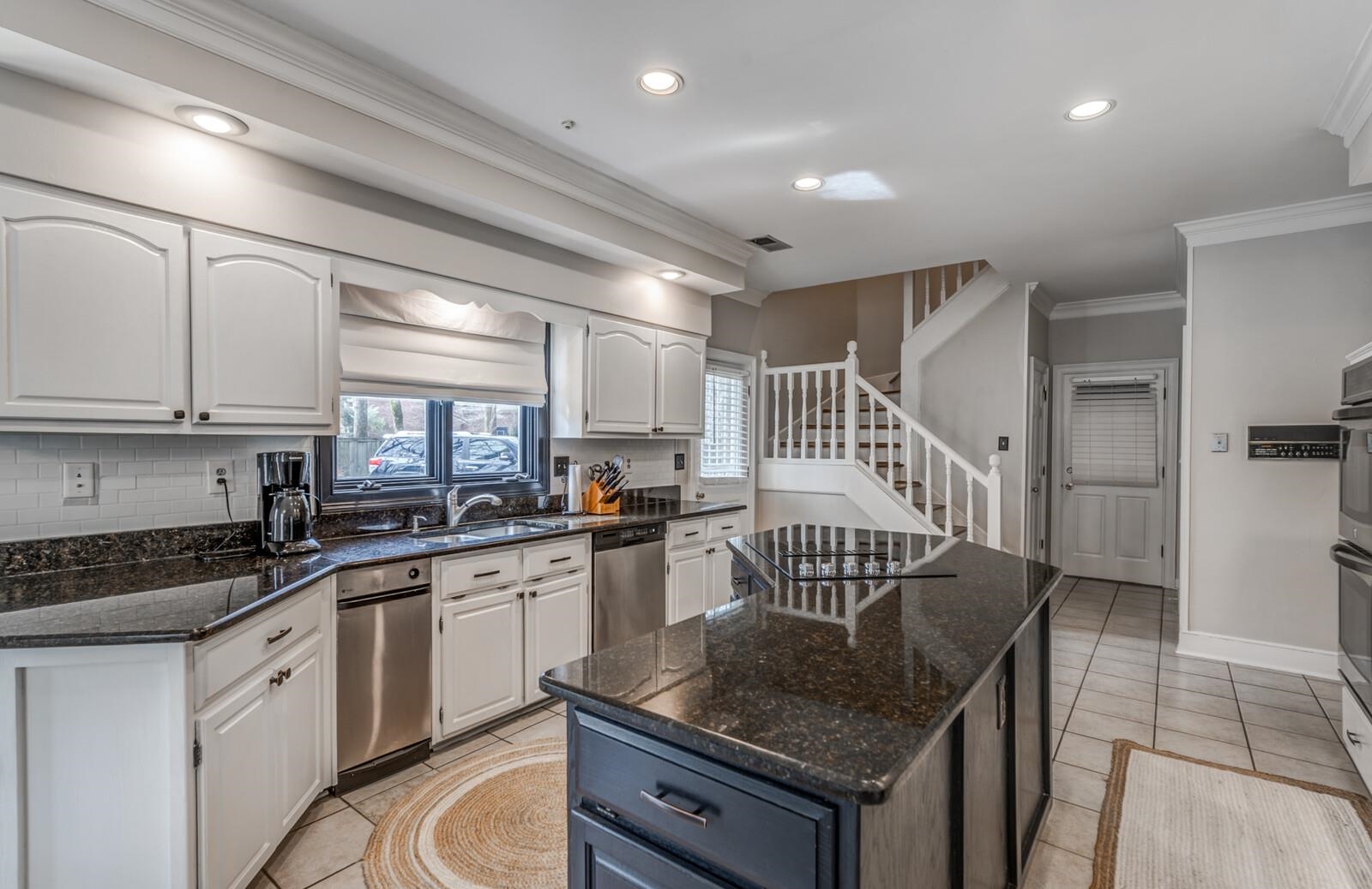 601 North Walnut Bend Road Memphis, TN 38018 - Photo 13 of 25 a kitchen with granite countertop a stove a sink a dining table and chairs
