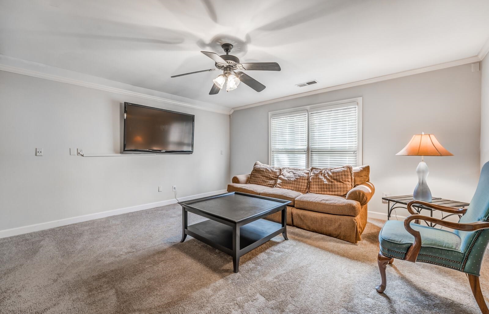 601 North Walnut Bend Road Memphis, TN 38018 - Photo 14 of 25 a living room with furniture a chandelier and a flat screen tv