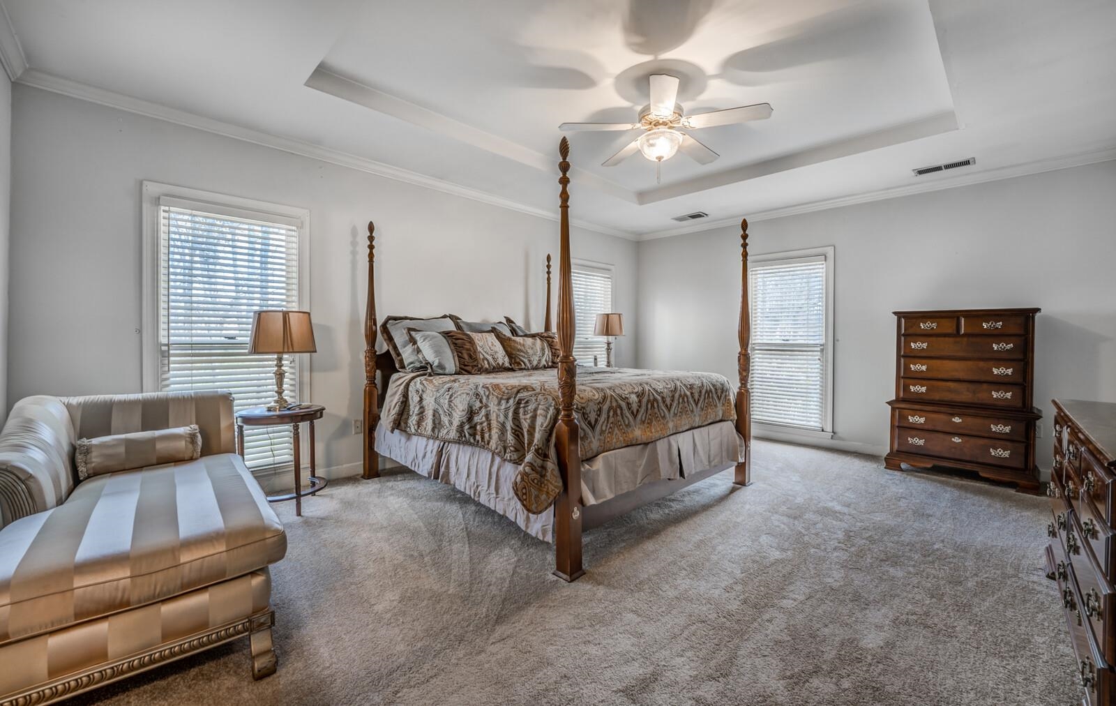 601 North Walnut Bend Road Memphis, TN 38018 - Photo 9 of 25 a spacious bedroom with a bed a couch and a chandelier