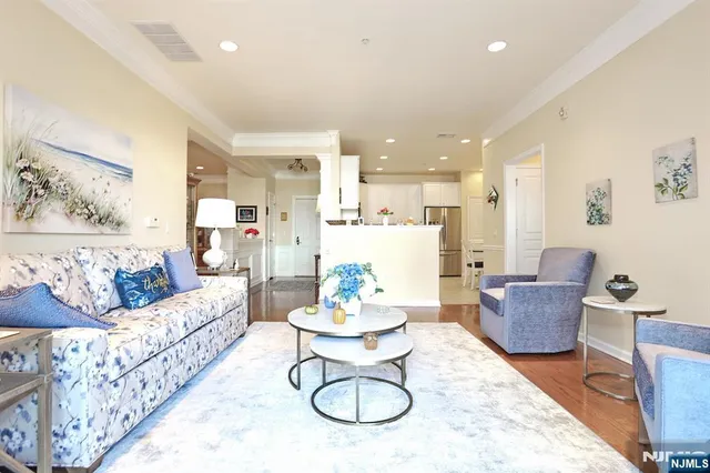 a living room with furniture and a dining table