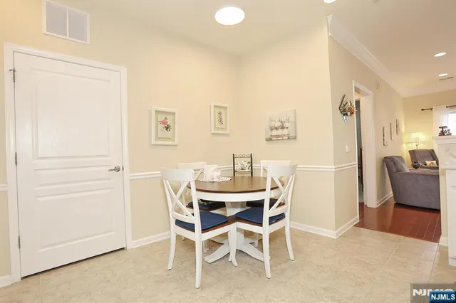 a view of a dining room with furniture and a chandelier