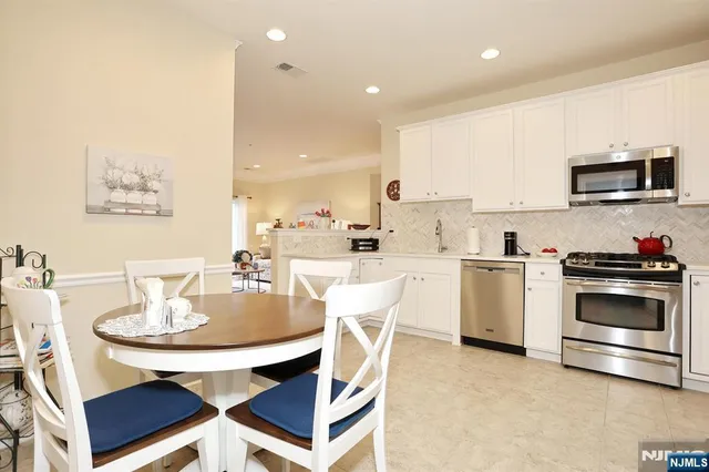 a kitchen with a stove a sink and a refrigerator