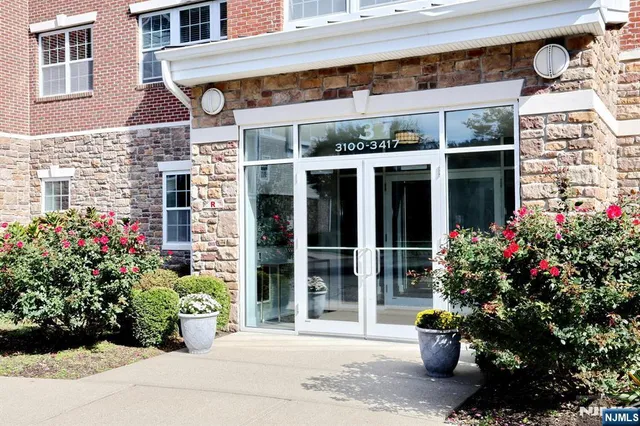 a front view of a building with potted plants