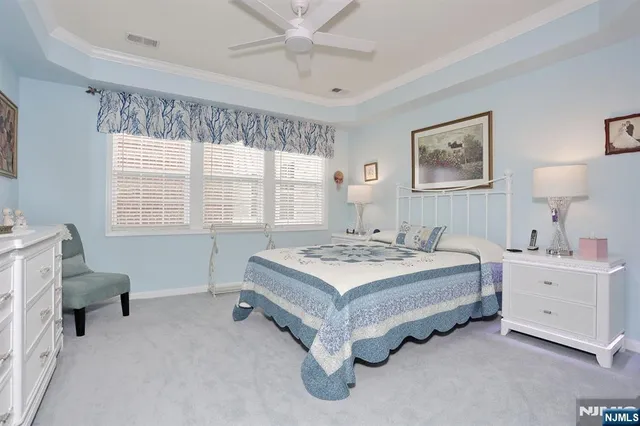 a spacious bedroom with a bed and a window