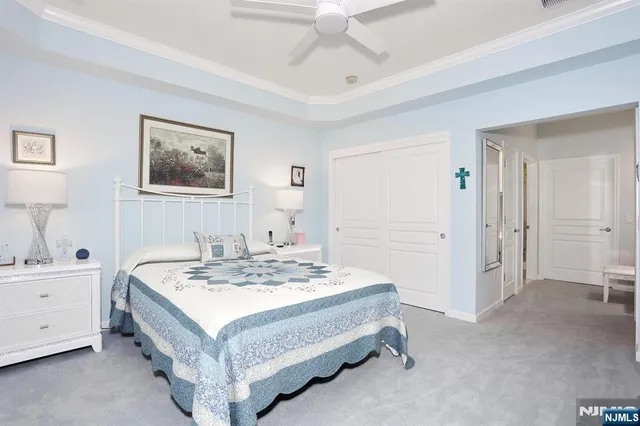 a spacious bedroom with a bed and a table in it