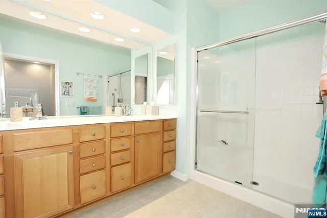 a bathroom with a shower sink and mirror