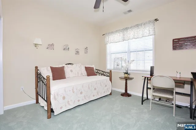 a bedroom with bed and a window