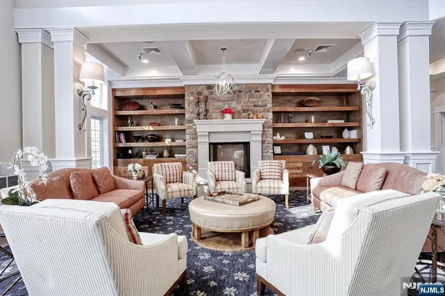 a living room with fireplace furniture and a fireplace