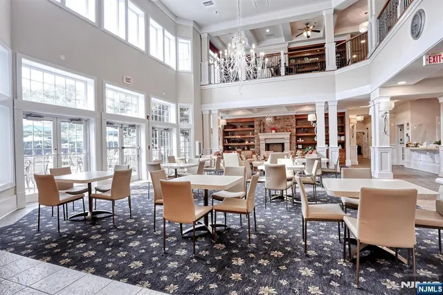 a living room with fireplace furniture and a large window