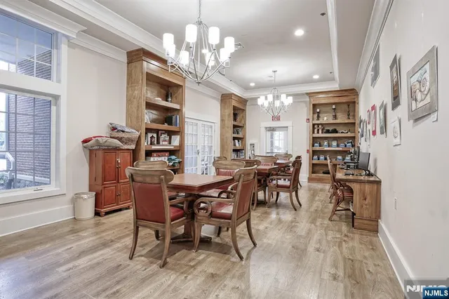 a view of a dining room with furniture and chandelier