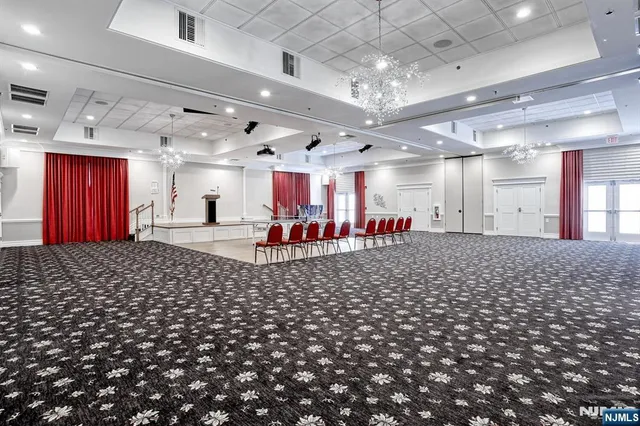 a room with lots of chairs and mirrors