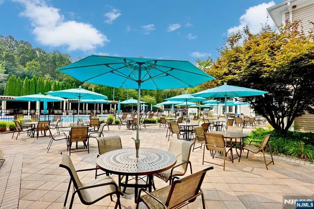 a house view with a swimming pool and wooden fence