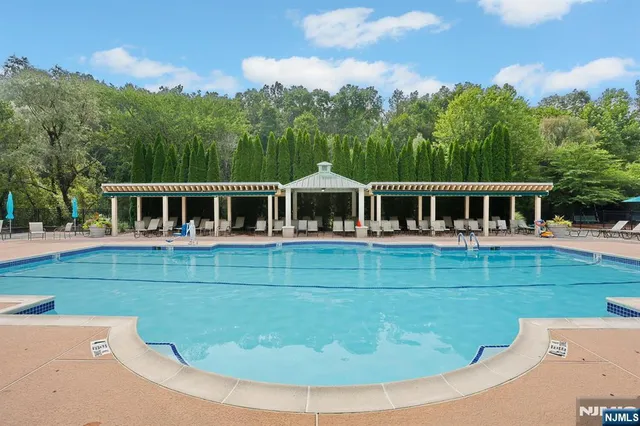 a view of a house with swimming pool and sitting area