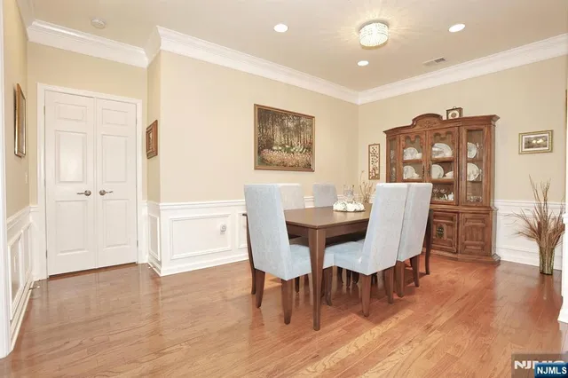 a view of a a dining room with furniture window and wooden floor