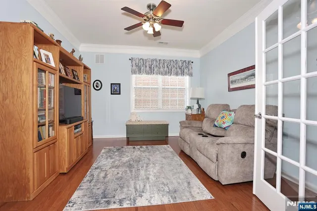 a living room with stainless steel appliances granite countertop furniture a fireplace and a window