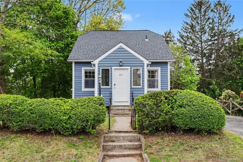 a front view of house with yard and green space