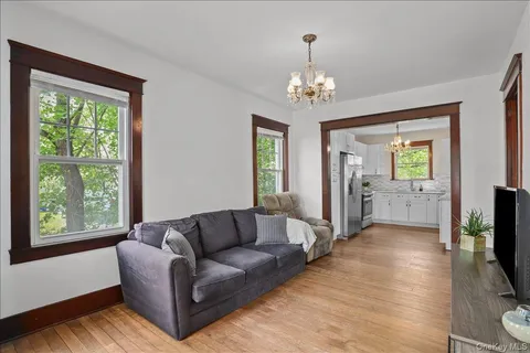 a living room with furniture and a chandelier
