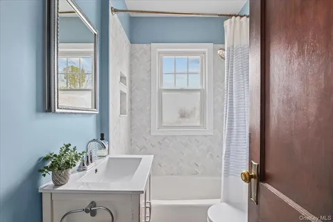 a bath room with a sink and a bath tub
