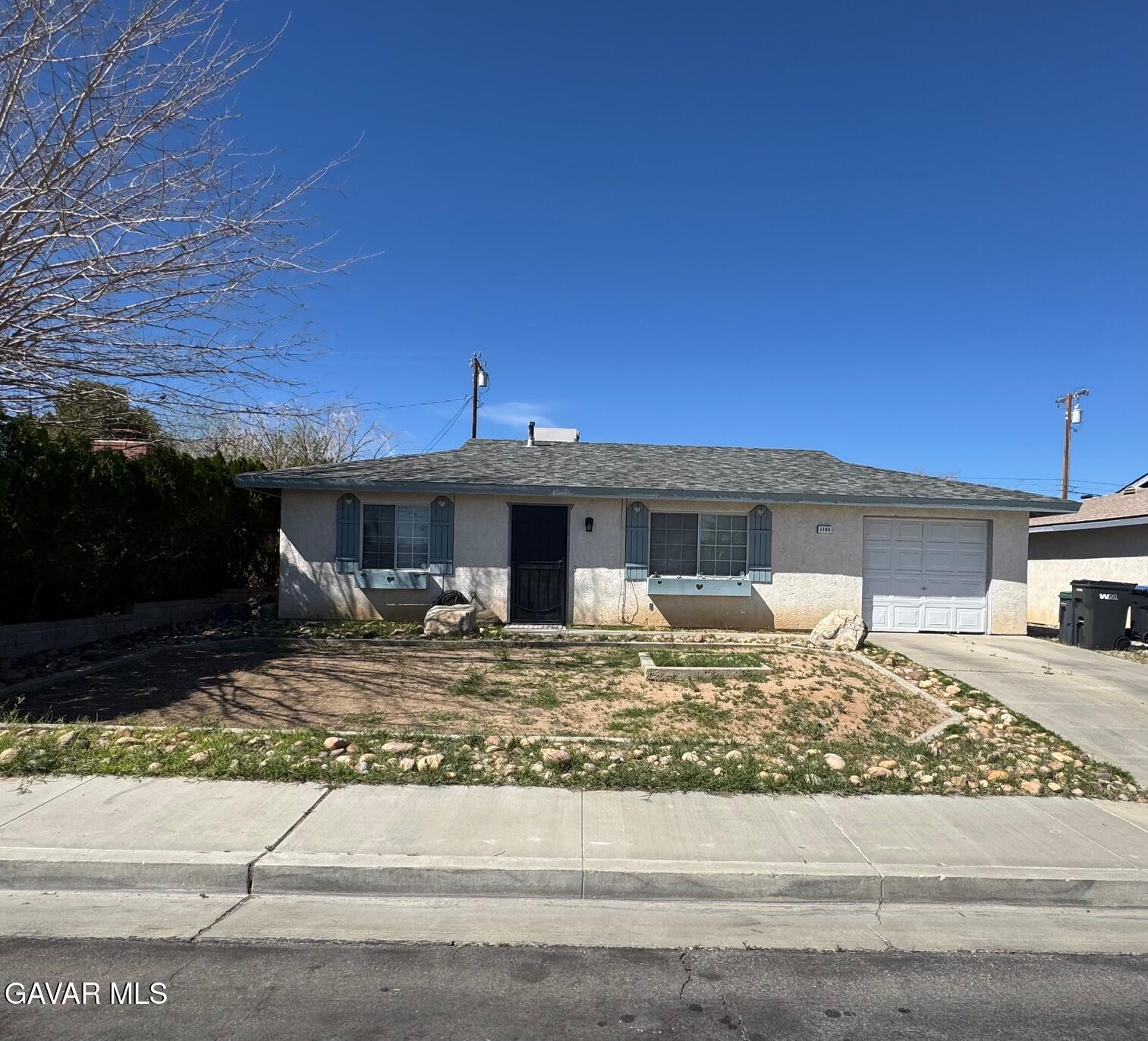 1105 South McCall Street Ridgecrest, CA 93555 - Photo 12 of 12 a front view of a house with a yard