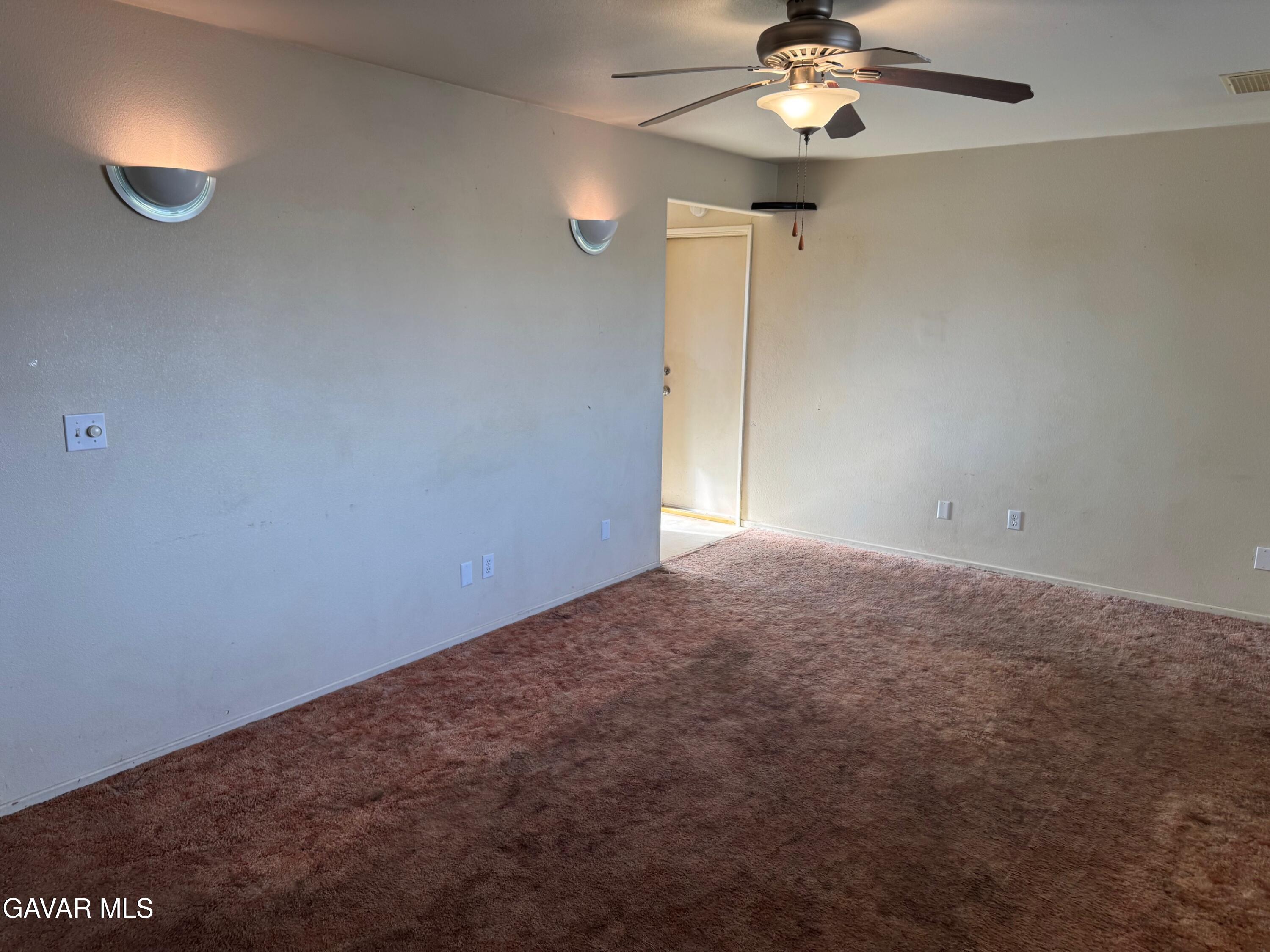 1105 South McCall Street Ridgecrest, CA 93555 - Photo 2 of 12 an empty room with fan and window