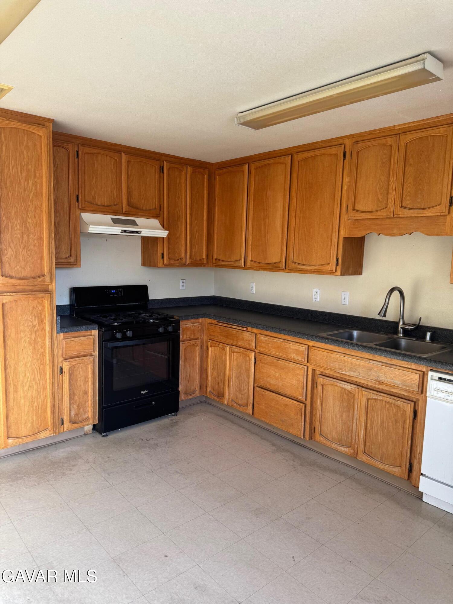 1105 South McCall Street Ridgecrest, CA 93555 - Photo 5 of 12 a kitchen with granite countertop a sink and cabinets