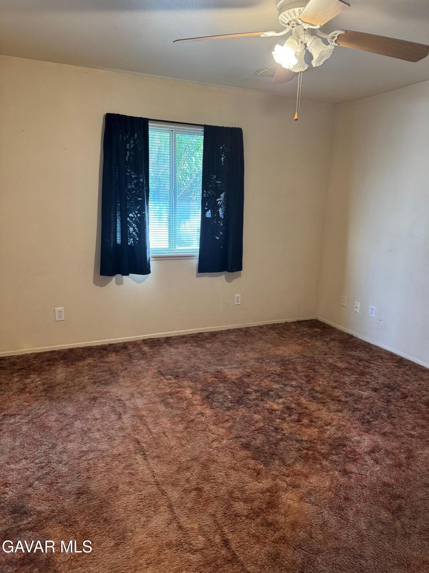 1105 South McCall Street Ridgecrest, CA 93555 - Photo 8 of 12 en empty room with windows and fireplace