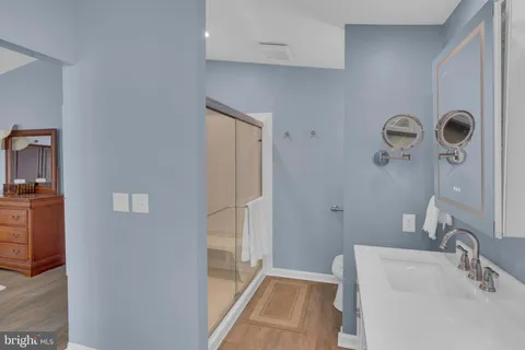 a bathroom with a sink a toilet and shower