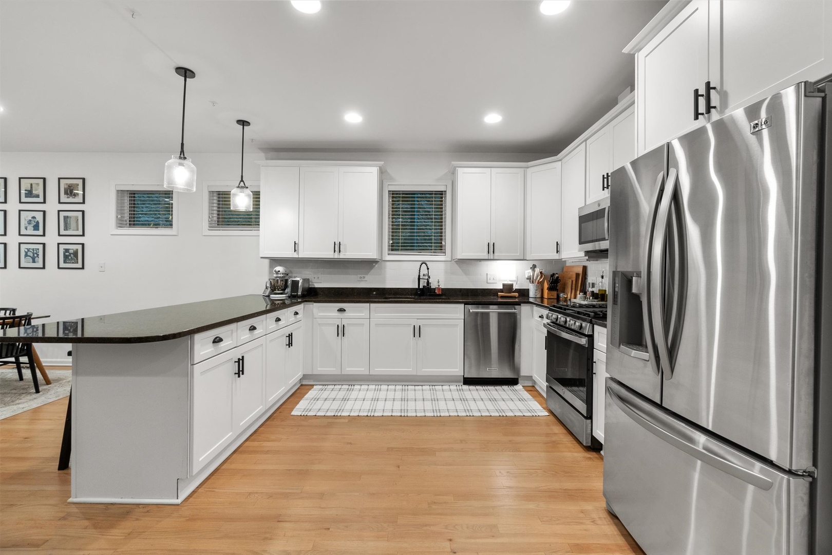 3531 North Reta Avenue, Unit 1 Chicago, IL 60657 - Photo 15 of 63 a kitchen with granite countertop a refrigerator a sink and white cabinets