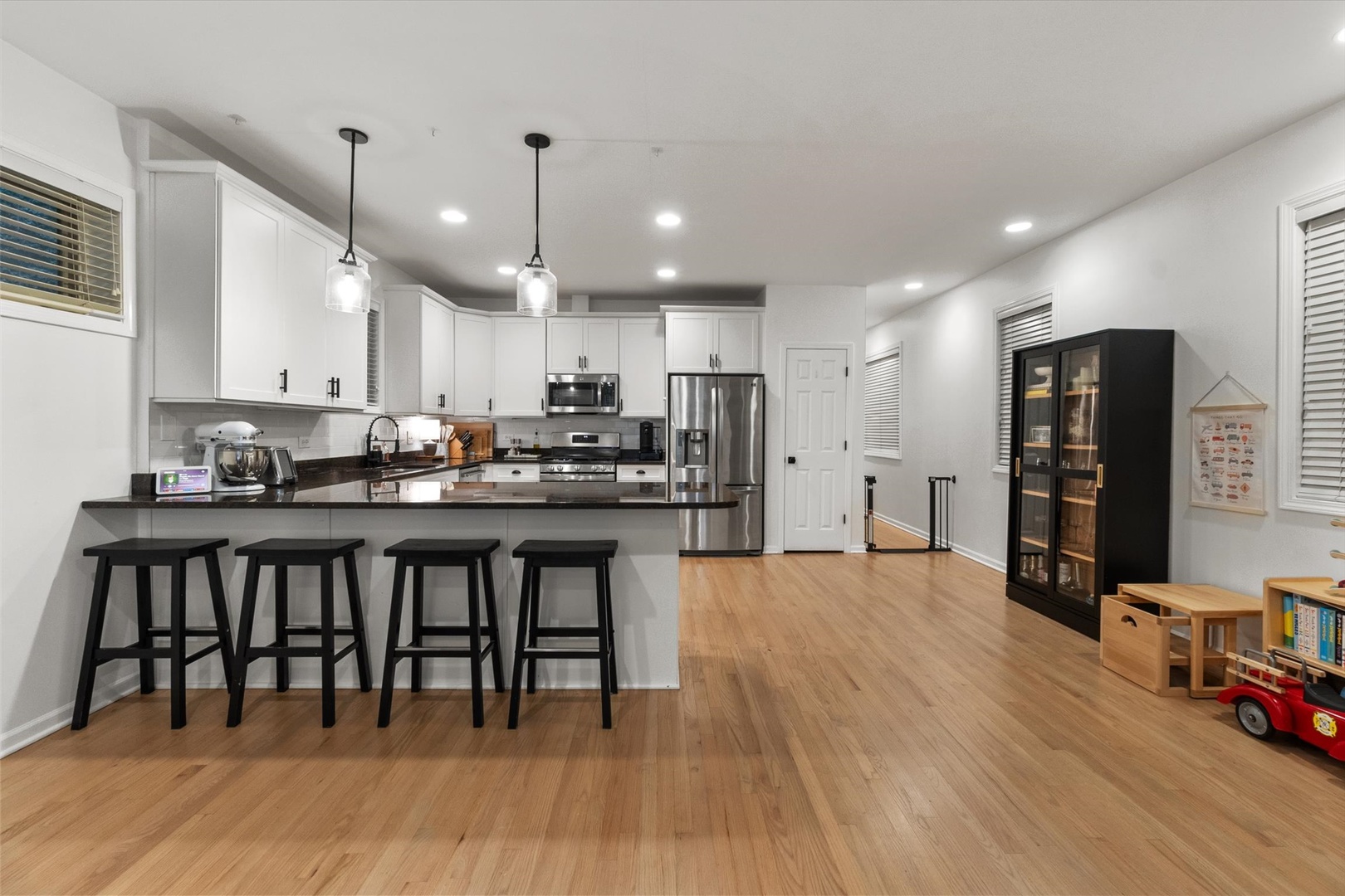 3531 North Reta Avenue, Unit 1 Chicago, IL 60657 - Photo 10 of 63 a kitchen with stainless steel appliances granite countertop a stove a refrigerator a kitchen island a sink and a refrigerator