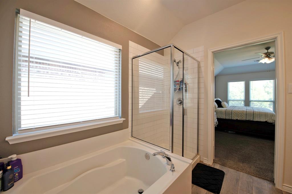 3970 Sidney Lane Forney, TX 75126 - Photo 15 of 25 a bathroom with a bathtub and a shower
