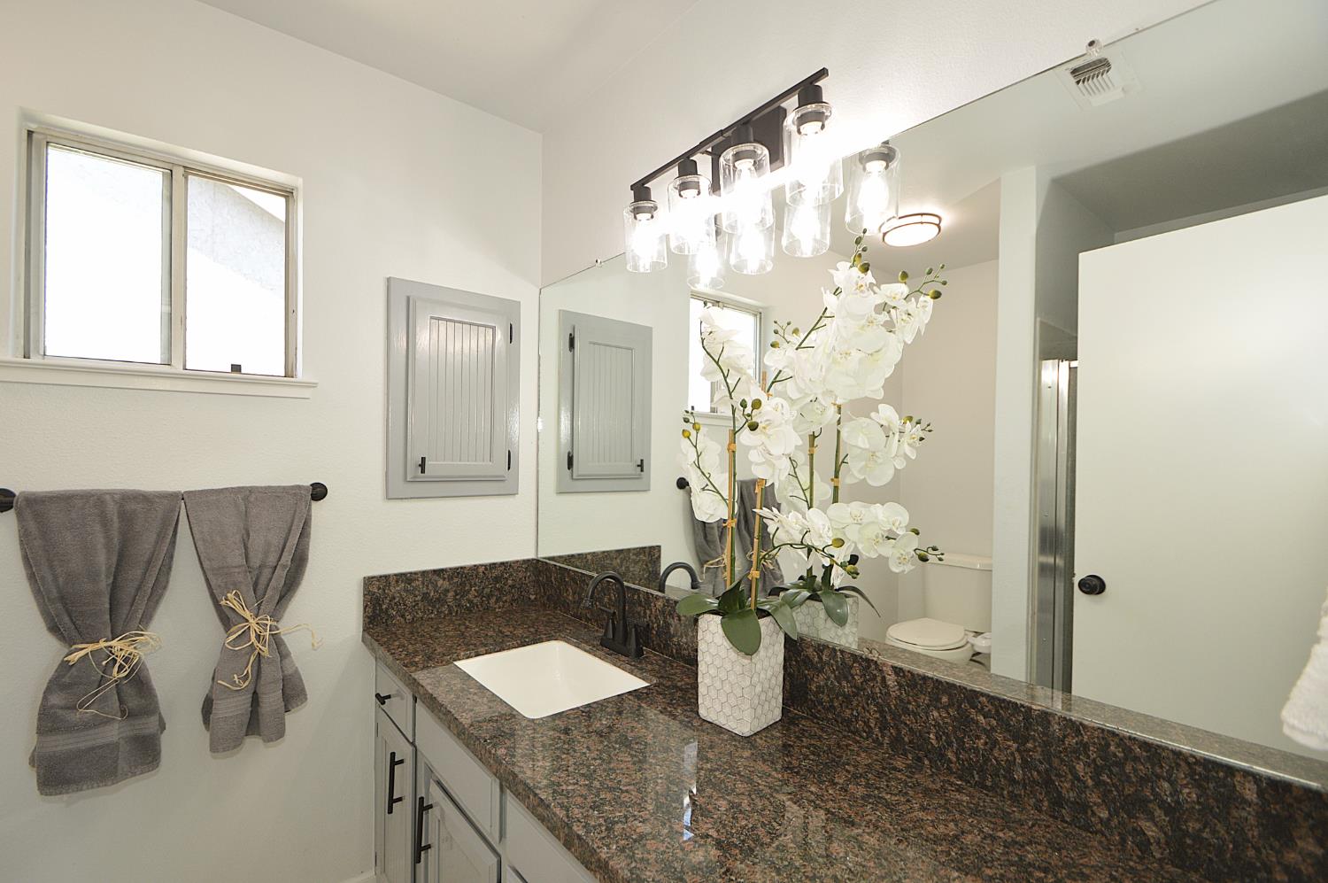 3290 North Rafael Avenue Fresno, CA 93722 - Photo 31 of 34 Master bathroom, new vanity lights, new faucets, new exterior paint