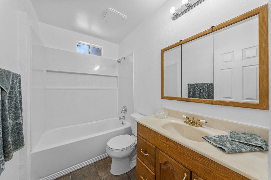 30265 Miller Road Valley Center, CA 92082 - Photo 29 of 56 a bathroom with a granite countertop sink toilet and shower