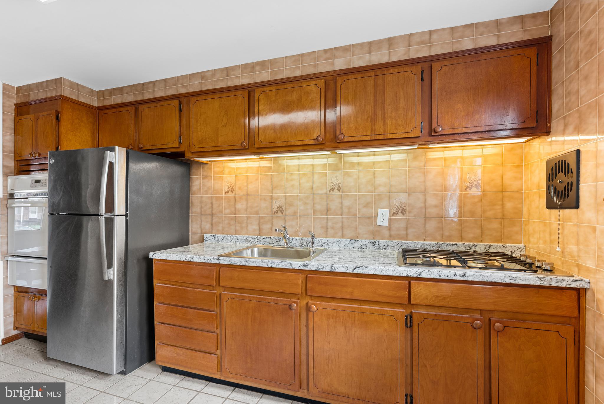 1041 Foxwood Lane Baltimore, MD 21221 - Photo 12 of 45 a kitchen with stainless steel appliances granite countertop a refrigerator and a stove top oven