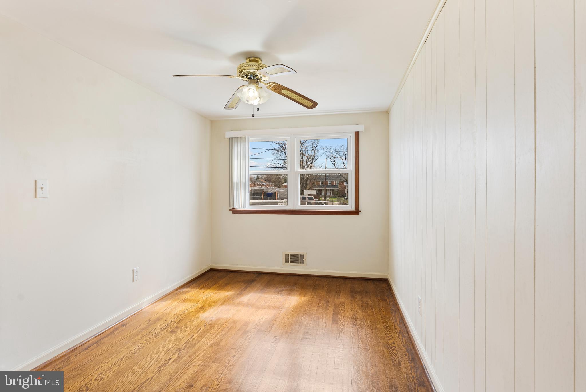 1041 Foxwood Lane Baltimore, MD 21221 - Photo 17 of 45 an empty room with windows and fan
