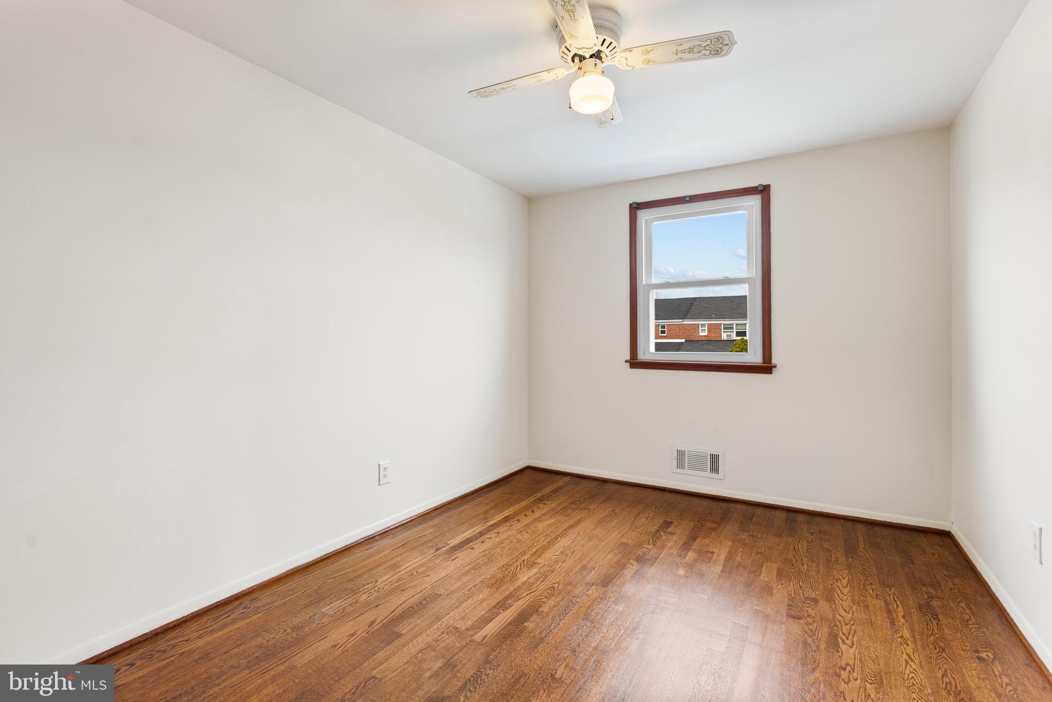 1041 Foxwood Lane Baltimore, MD 21221 - Photo 29 of 45 an empty room with a window and wooden floor