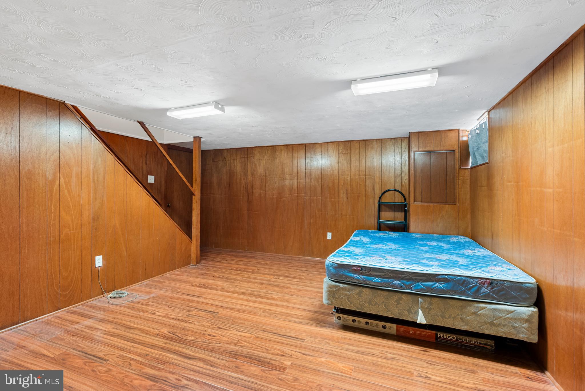 1041 Foxwood Lane Baltimore, MD 21221 - Photo 33 of 45 a bedroom with bed and wooden floor