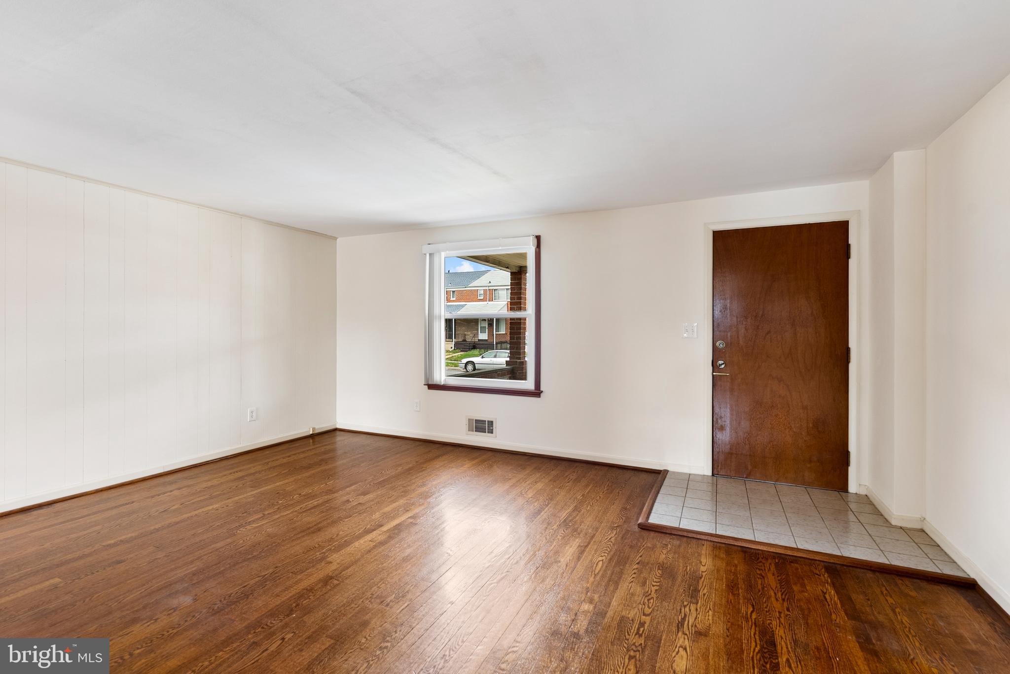 1041 Foxwood Lane Baltimore, MD 21221 - Photo 7 of 45 an empty room with wooden floor and windows