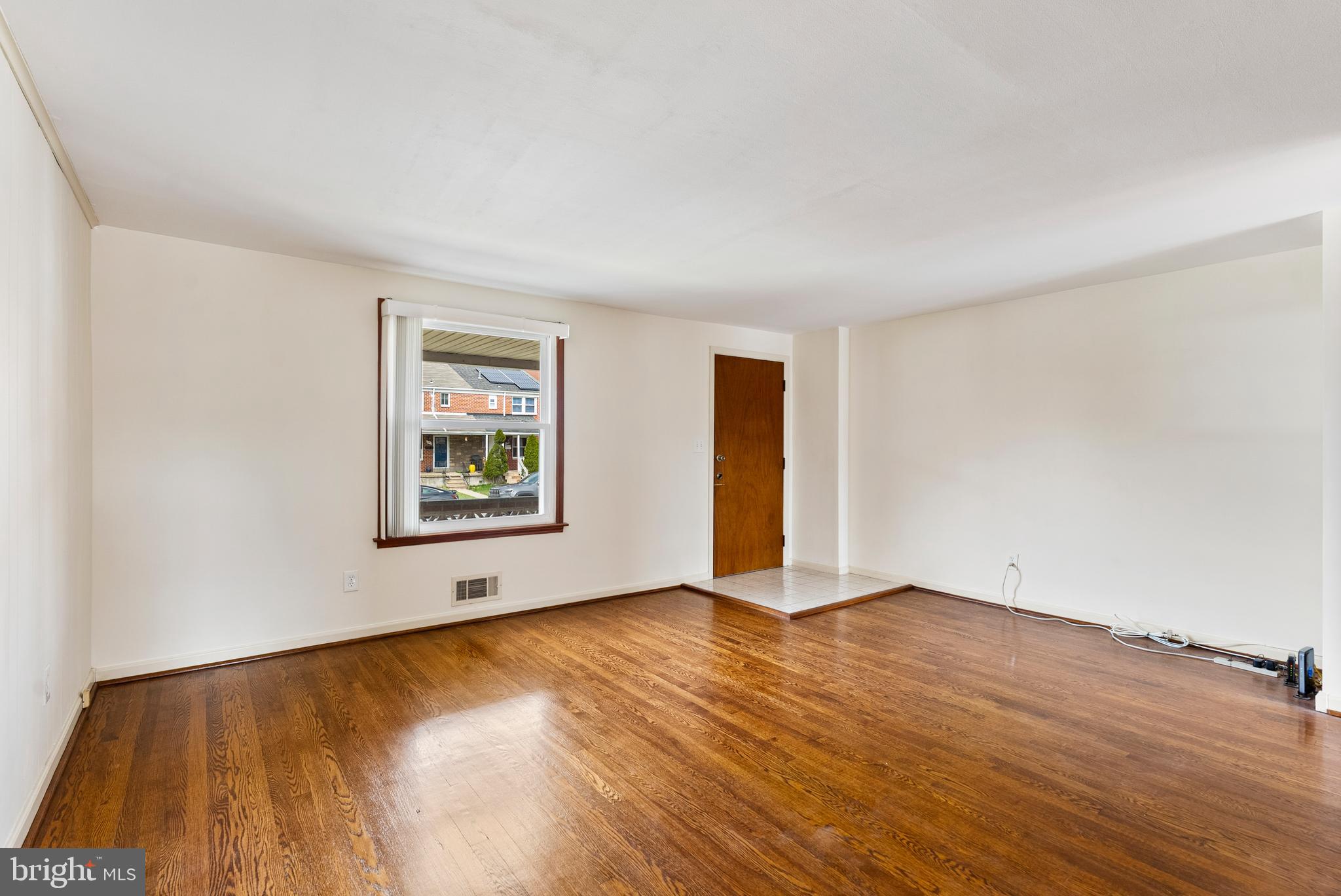 1041 Foxwood Lane Baltimore, MD 21221 - Photo 8 of 45 a view of an empty room with wooden floor and a window