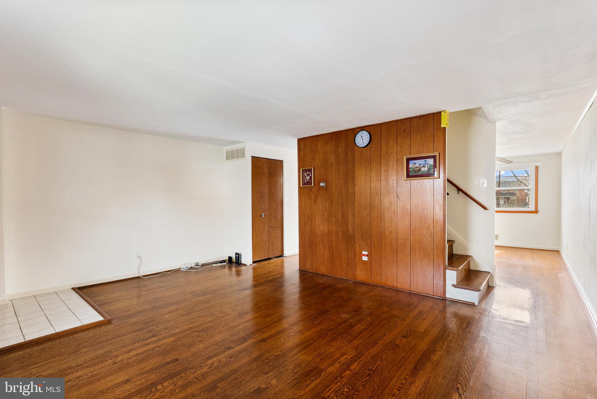1041 Foxwood Lane Baltimore, MD 21221 - Photo 9 of 45 a view of an empty room with wooden floor and a window