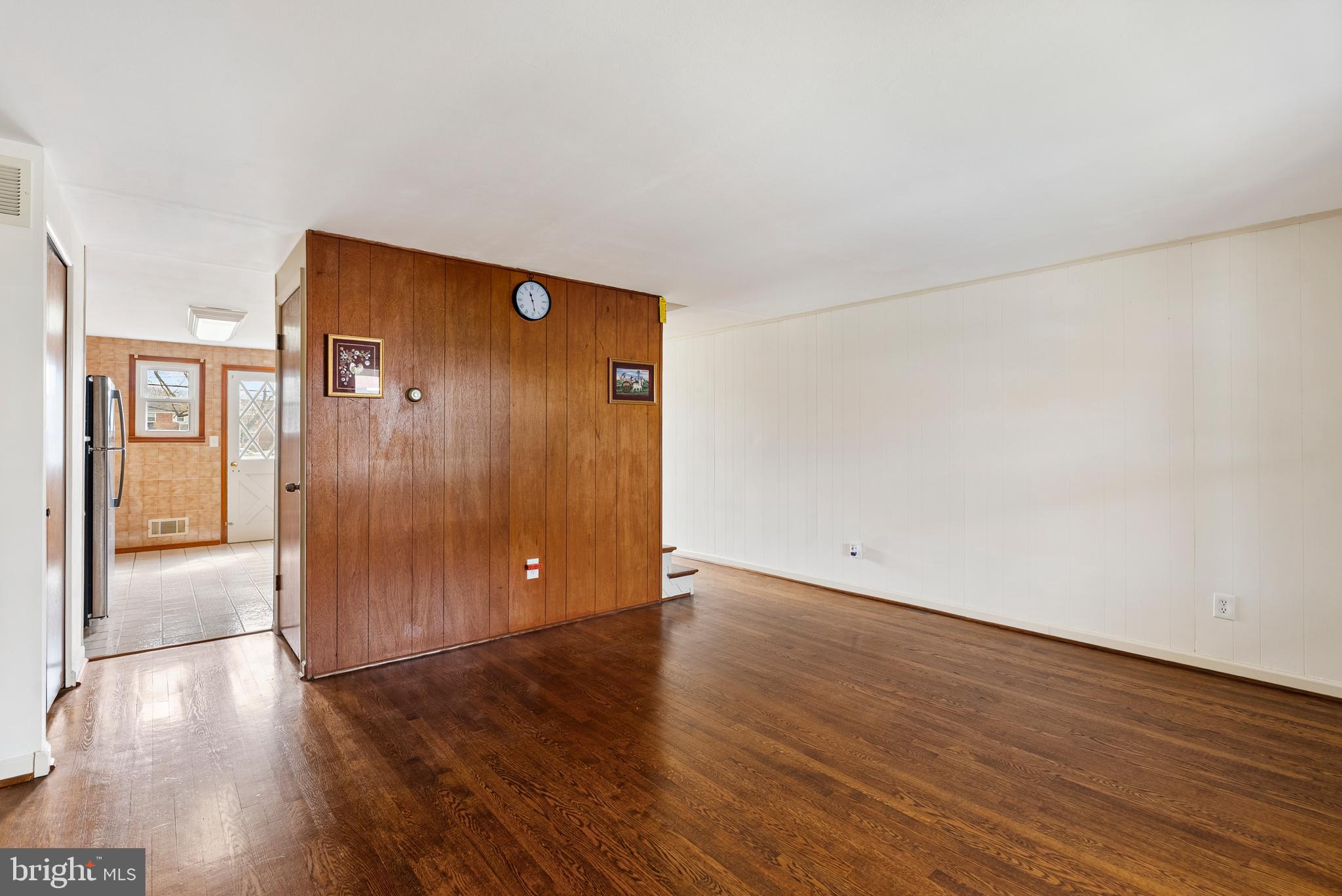 1041 Foxwood Lane Baltimore, MD 21221 - Photo 10 of 45 a view of an empty room with wooden floor and a window